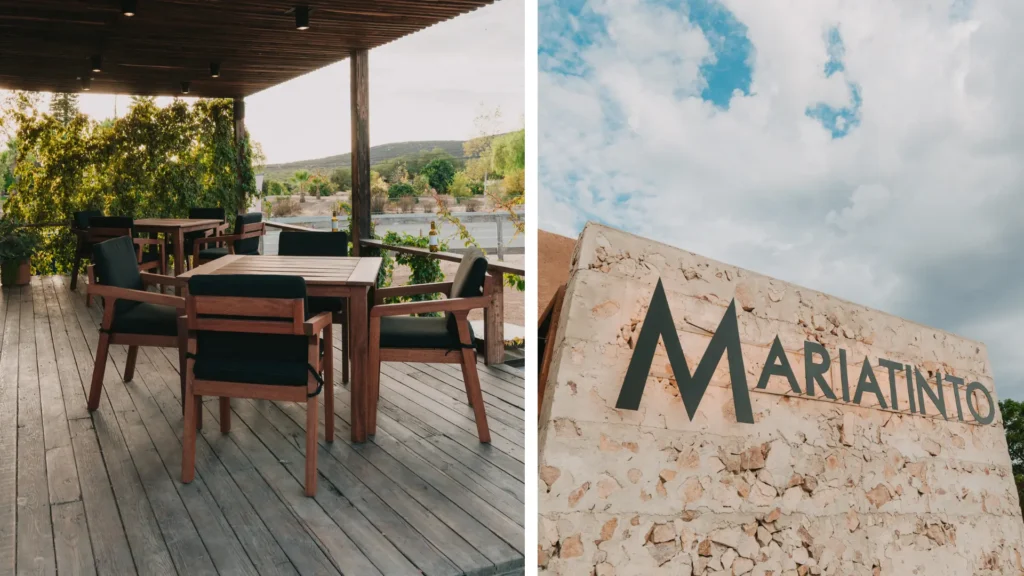 Terraza con mesas y sillas de madera y fachada de piedra con el logotipo Mariatinto en Valle de Guadalupe, Baja California.
